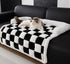 Black Muffy pet couch cover draped over a sofa, 75x75cm, protecting furniture from pet fur and mess.