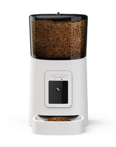 Black Muffy automatic pet feeder with camera, featuring a digital display and food tray for convenient pet feeding.
