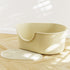 Creamy white large open cat litter box with splash guard by Muffy, featuring high sides and easy access for cats.
