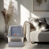 Large stainless steel fully enclosed cat litter box by Muffy with a gray finish and pedal opening for easy access.