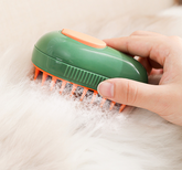 Muffy electric pet brush with spray in green, designed for grooming cats and dogs with a comfortable handle and spray feature.