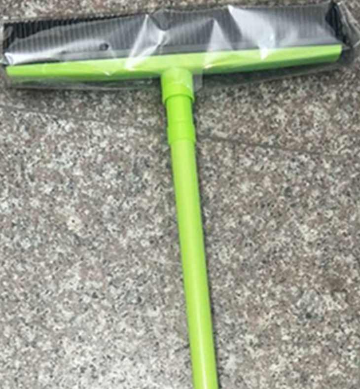 Orange Muffy pet hair removal broom with long handle and rubber brush for easy cleaning of pet hair from floors and furniture.