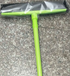 Orange Muffy pet hair removal broom with long handle and rubber brush for easy cleaning of pet hair from floors and furniture.